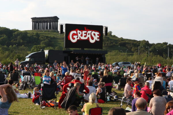 live band on stage with screen